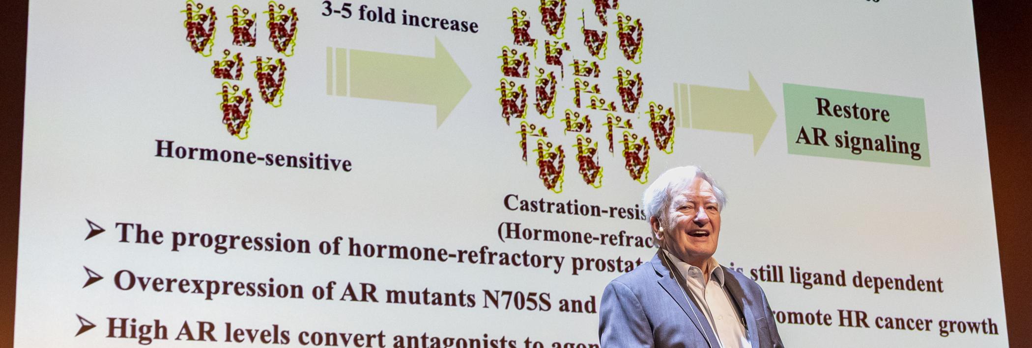 Professor Michael E. Jung presenting a slide. 